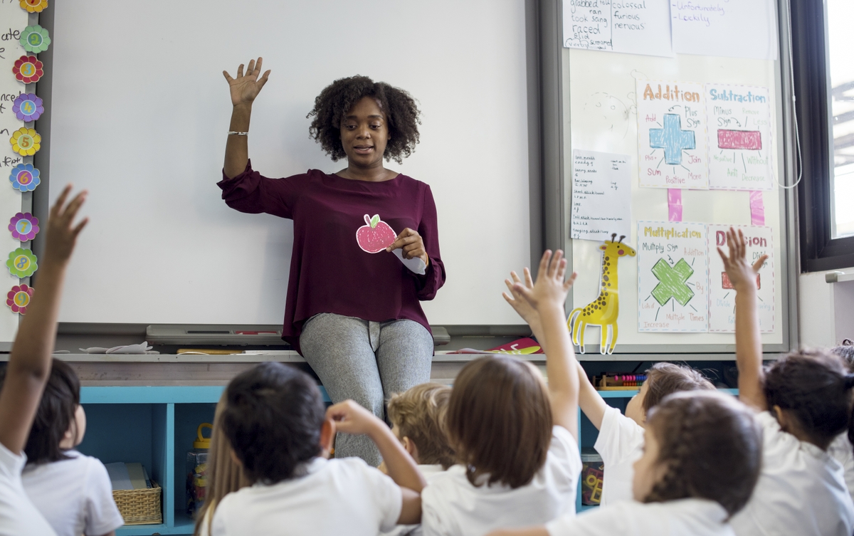 Teacher with raised hands